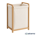Modern oak frame laundry hamper in a bright laundry room